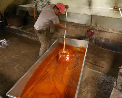 Making panela by hand A man stirs panela, a deep brown syrup made from sugar cane