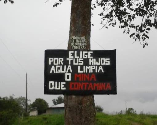 The choice is simple: clean water or mines that poison the water A sign on a tree that says "Do you choose clean water for your children or mining that contaminates"